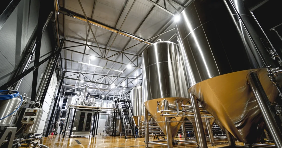 Stainless steel fermentation tanks in a craft brewery.
