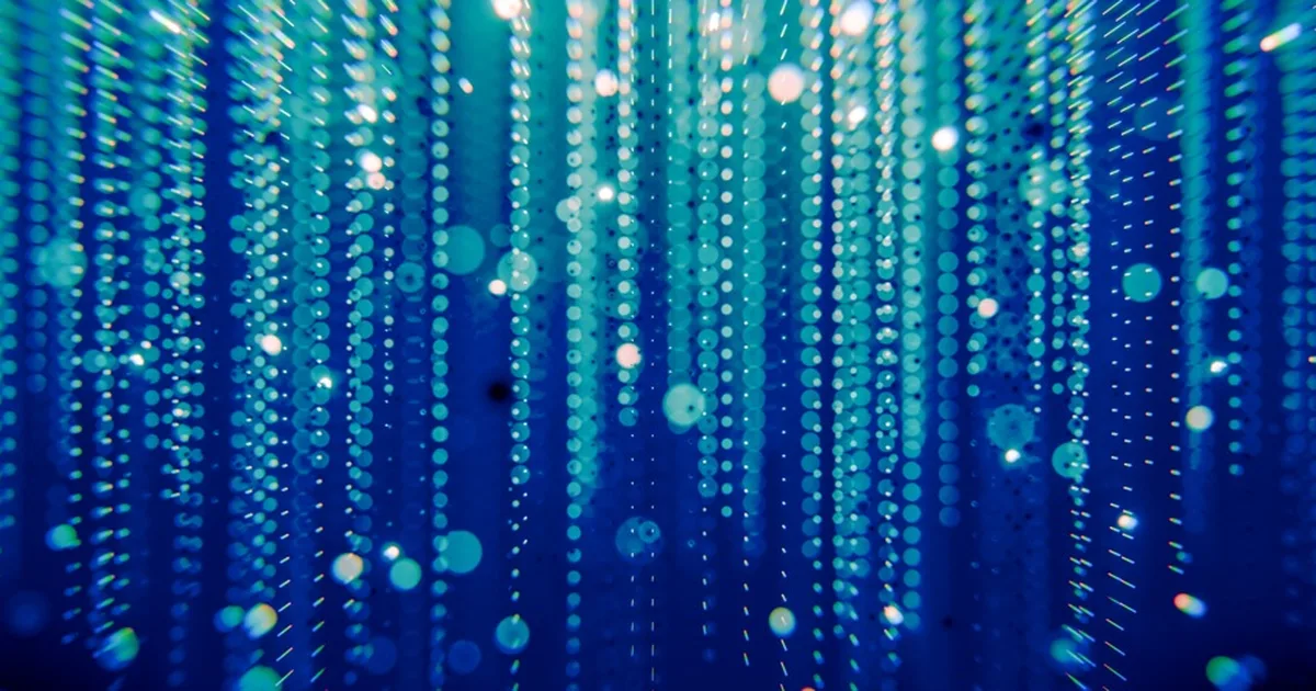Abstract blue and teal light streaks representing energy data flow.