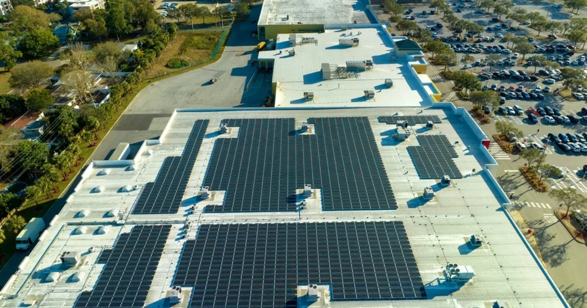 Aerial view of solar panels on a commercial retail rooftop.