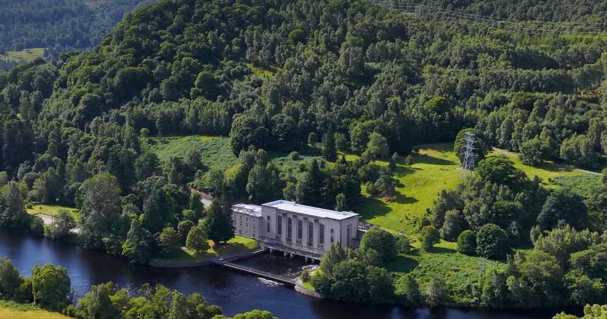 Aerial view of a hydro power station on a highland river.